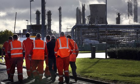 Workers walk through the Grangemouth oil refinery