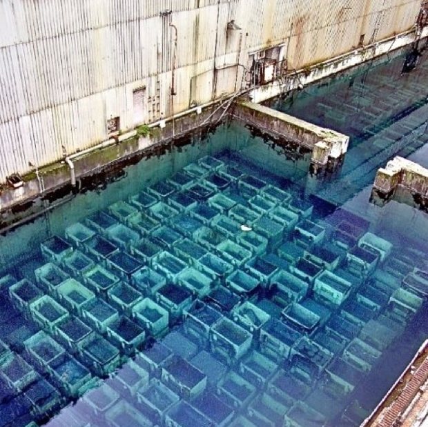 Shitty open-air pond at Sellafield nuclear waste dump containing spent nuclear fuel rods.