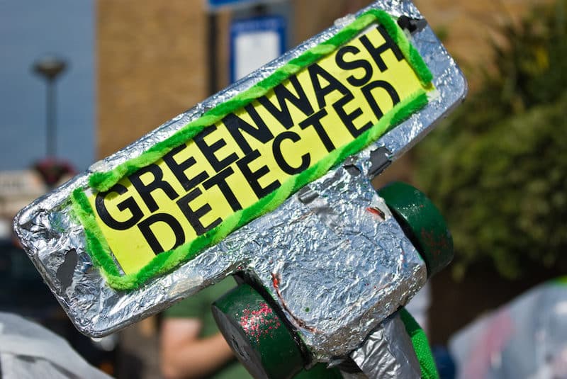 Protest placard reads Greenwash detected