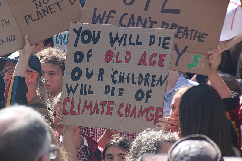 Image contains protest banner readng You will die of old age, our children will die of climate change - Melbourne climate strike